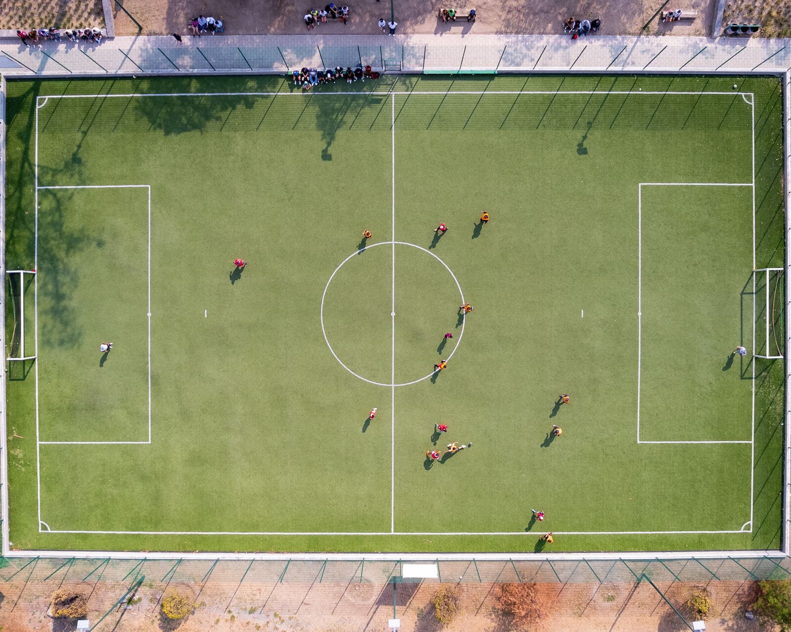 Two footballers standing off between a ball